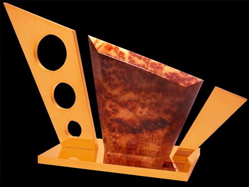 If you sense of bit of motorcycle in the design, you’d be right. This particular piece, simply titled “GoldenWood” measures 22-inches long, six inches wide, 12.5 high.
